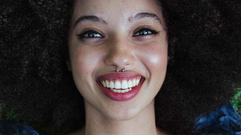 smiling woman with septum piercing