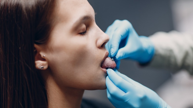 Person getting tongue pierced 