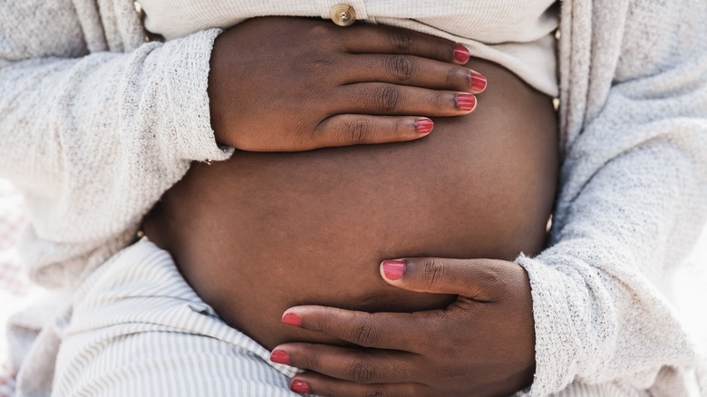 pregnant woman with hands on belly