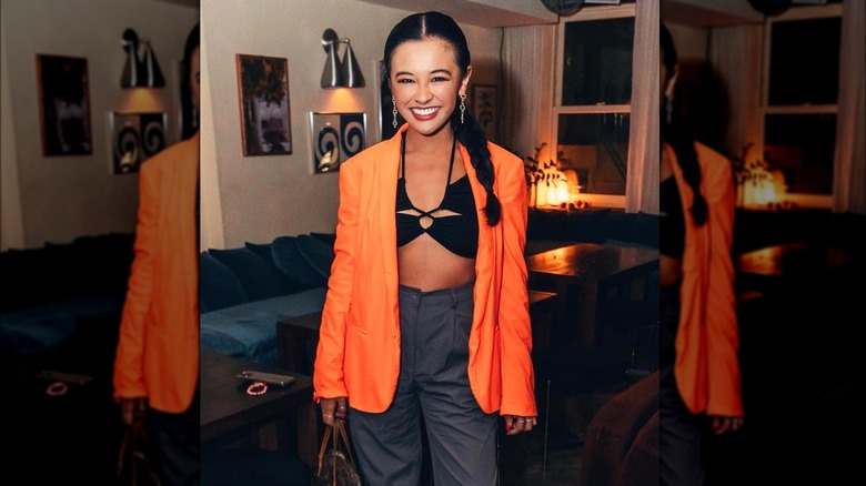 Megan Uy wearing orange blazer