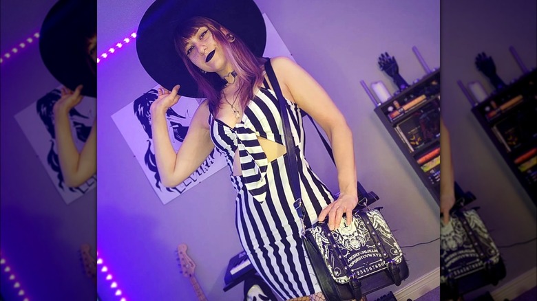 Woman wearing striped dress and black hat