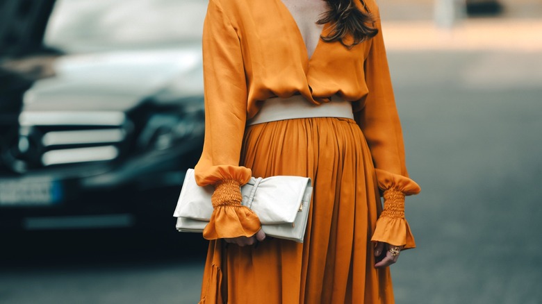 Woman wearing long-sleeved orange dress