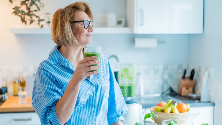 A woman drinking a smoothie 