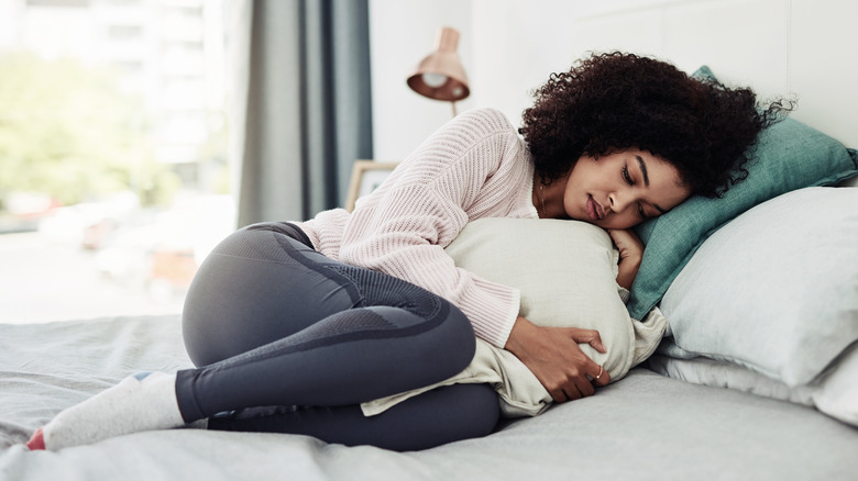 Woman lying down on bed