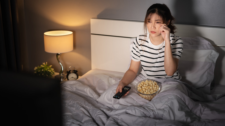 Woman watching a movie in bed