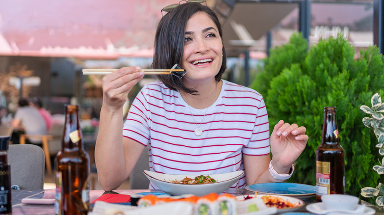 Woman eating sushi