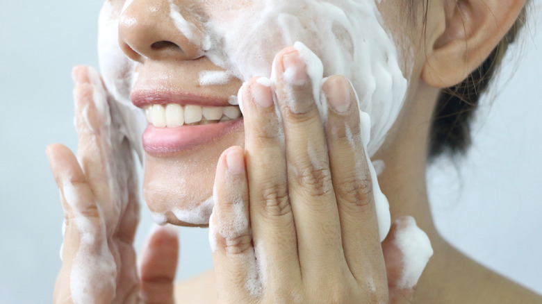 woman washing her face