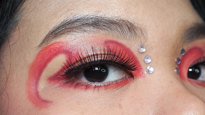 Red eyeshadow design with face gems