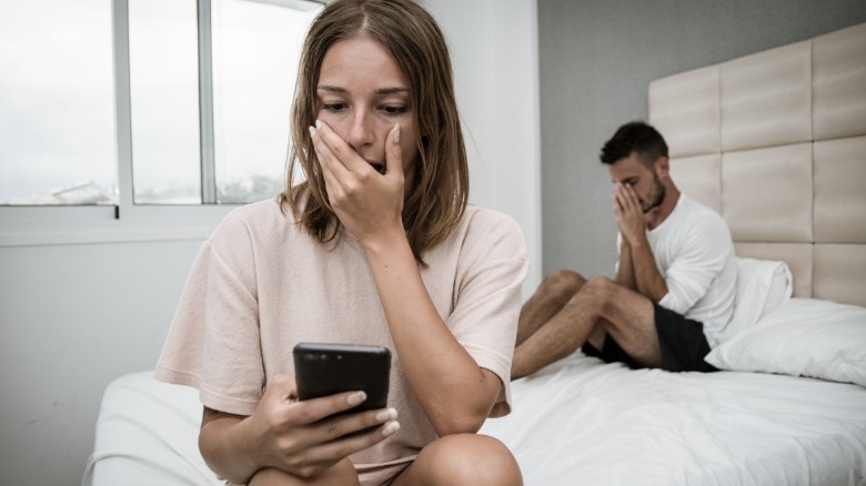 Shocked woman looking at phone