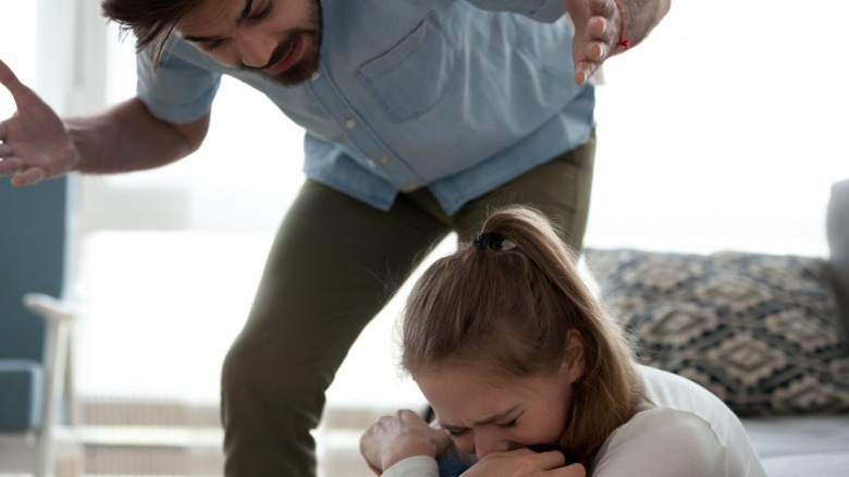 Man screaming at scared woman