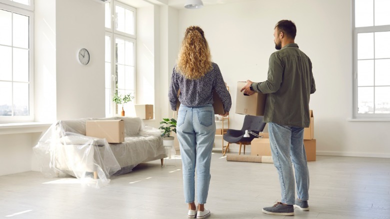 Man and woman holding boxes