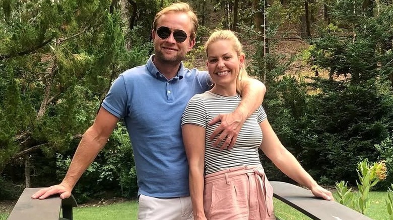 Valeri Bure grabbing Candace Cameron Bure's breast while posing for a photo.