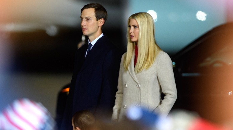 Ivanka Trump and Jared Kushner standing alone at a political rally.