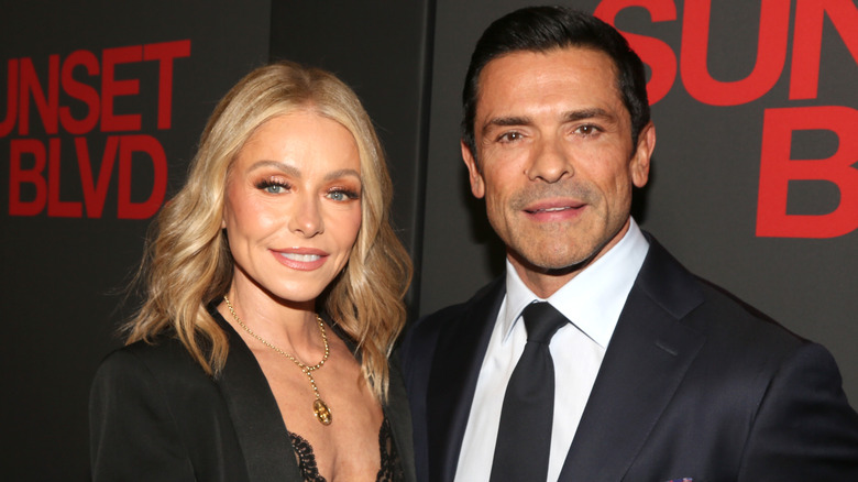 Kelly Ripa and Mark Consuelos posing on a red carpet together.