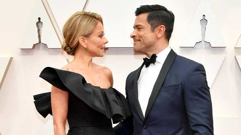 Kelly Ripa and Mark Consuelos smiling at each other.