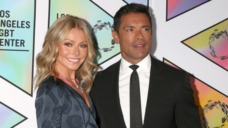 Kelly Ripa and Mark Consuelos posing for photos together.