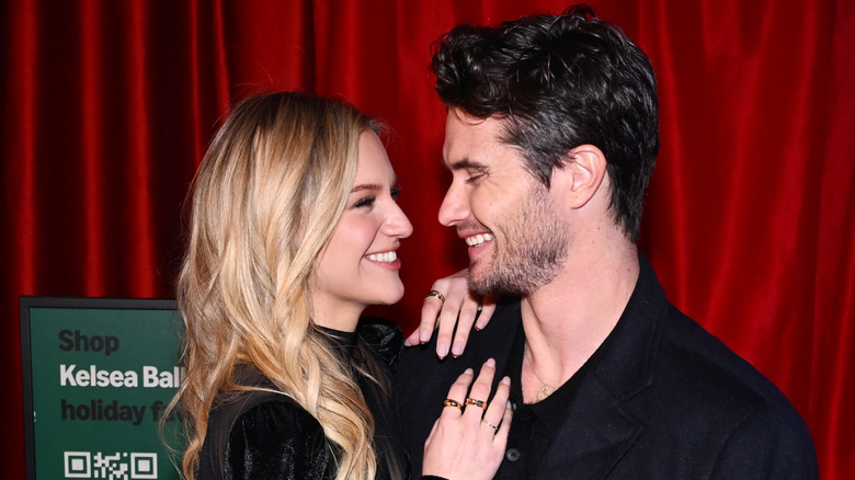 Kelsea Ballerini and Chase Stokes smiling at each other