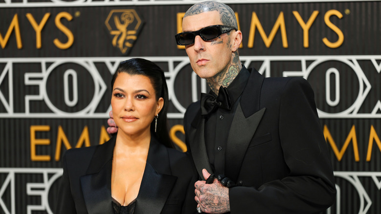 Kourtney Kardashian and Travis Barker posing together at the Emmys.