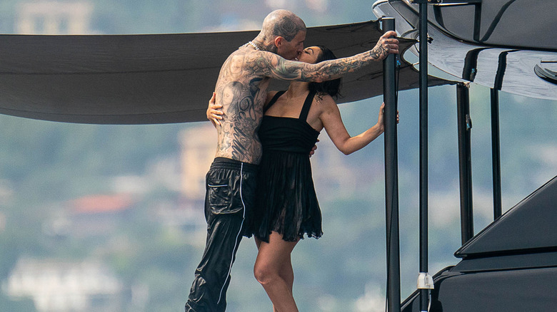 Kourtney Kardashian and Travis Barker kissing on a boat.