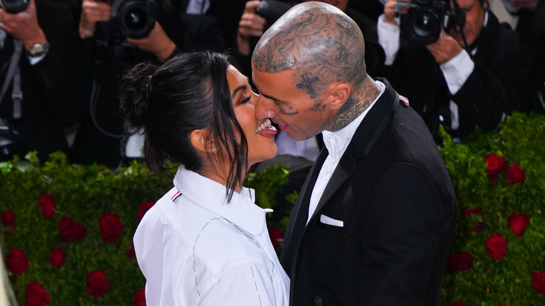 Kourtney Kardashian and Travis Barker kissing at the Met Gala.