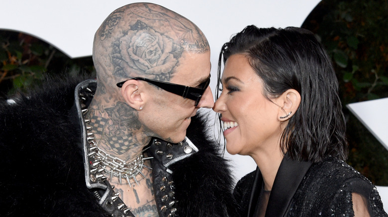 Kourtney Kardashian and Travis Barker about to kiss each other.