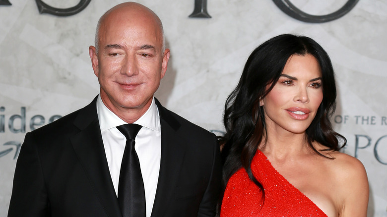 Jeff Bezos and Lauren Sanchez looking away from each other