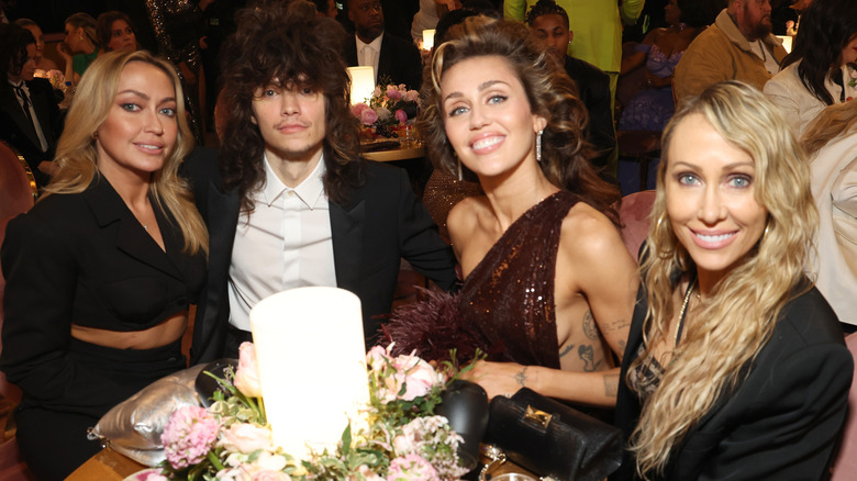 Miley Cyurs and Maxx Morando attending the 2024 Grammy Awards with Miley's sister and mom.