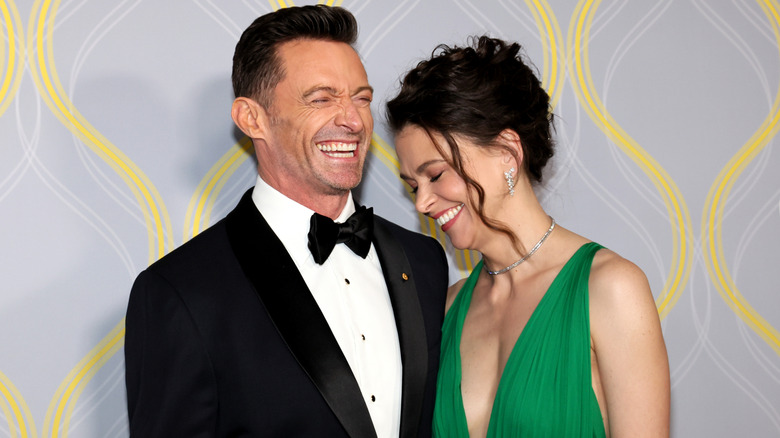 Sutton Foster and Hugh Jackman laughing at a red carpet event together.