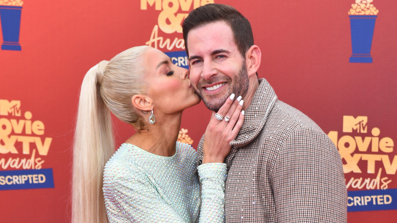 Tarek and Heather Rae El Moussa posing at the MTV Movie & TV Awards red carpet.