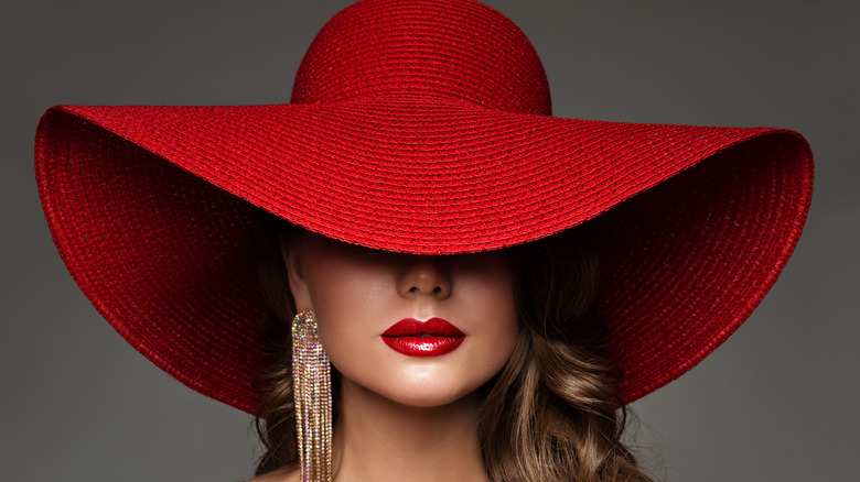 Model wearing oversized red hat
