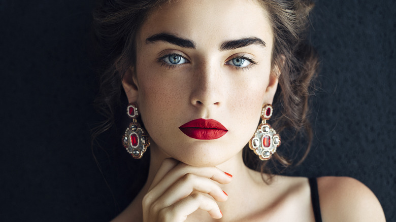 Woman wearing red dangly earrings 