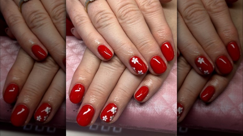 Red nails with flower accents