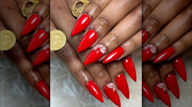 Pointy red nails with pearl accent