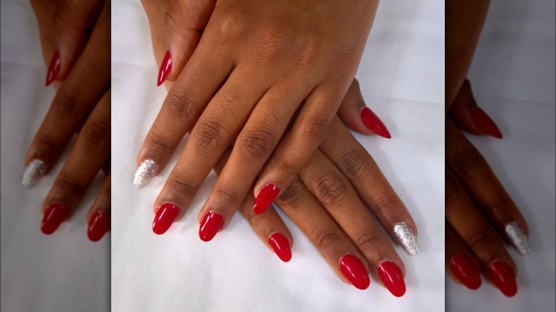 Red nails with silver glitter accent