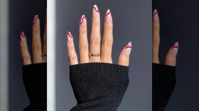 Swirly red and white lines nails