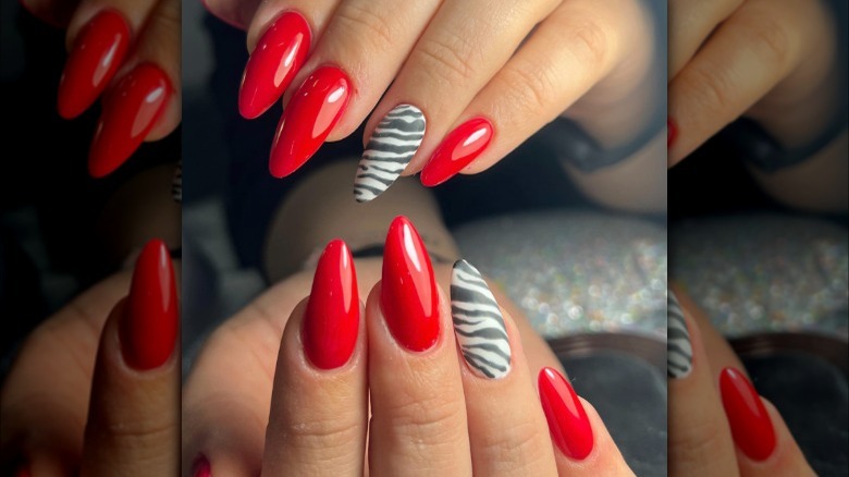 Red nails with zebra print accent