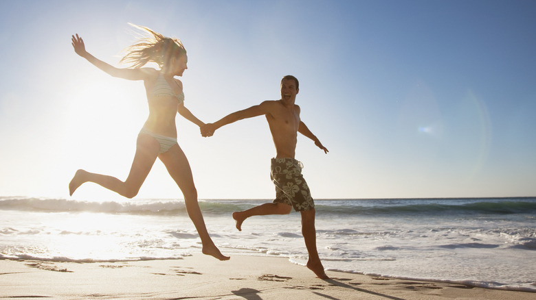 Couple running on beach 