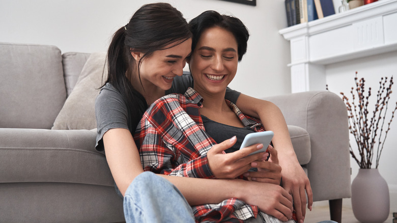 two women looking at phone