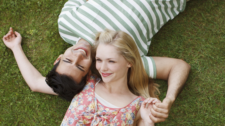 couple laying on the grass