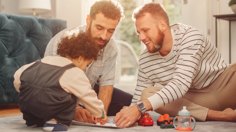 couple playing with baby