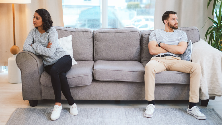 couple sitting apart on couch