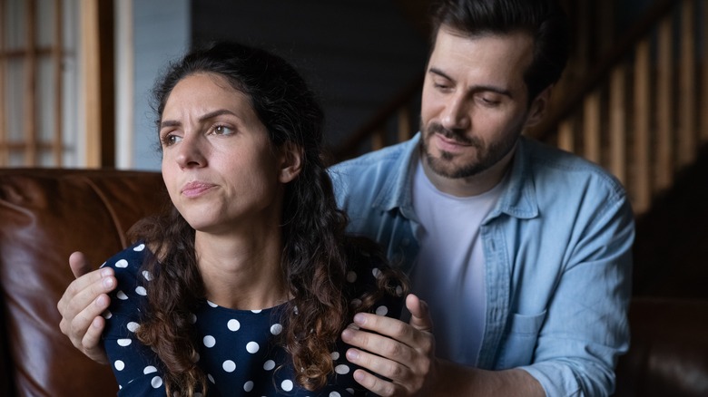 man holding unhappy woman