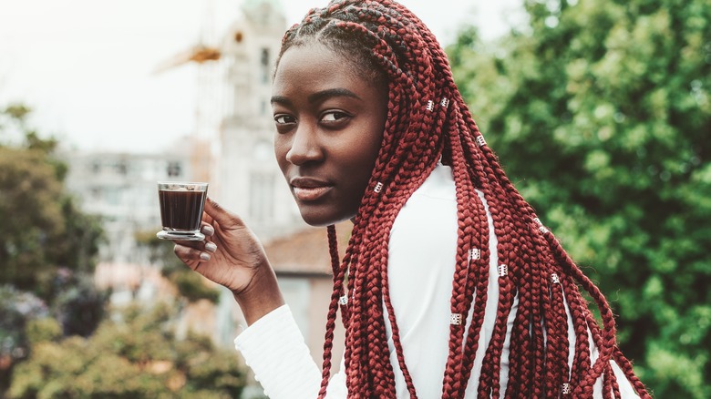 Woman with burgundy braids and espresso