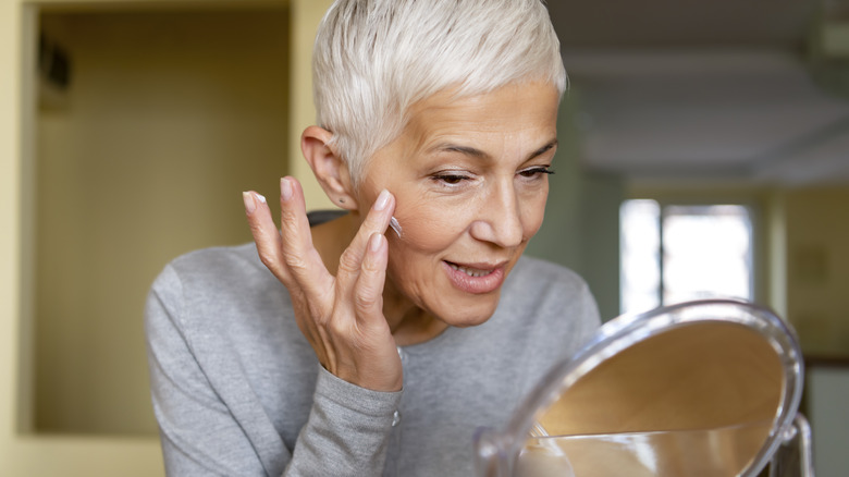 woman applying moisturizer