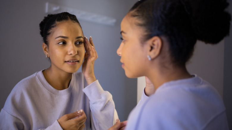 woman looking in mirror