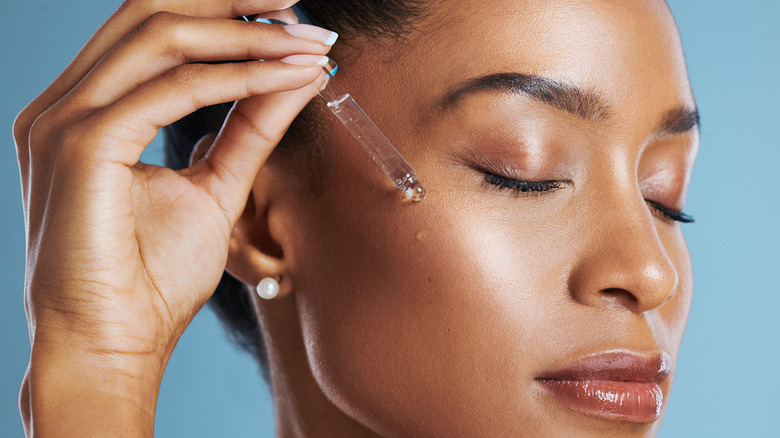 Woman applying glycolic acid to face