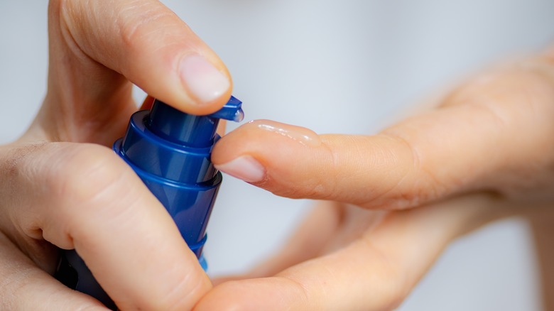 A woman applying a serum