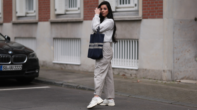 Woman wearing khakis, retro sneakers