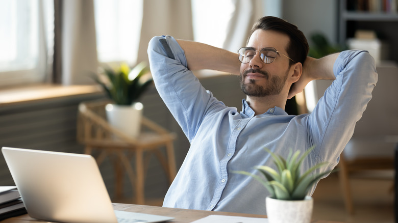 Man closing eyes at desk