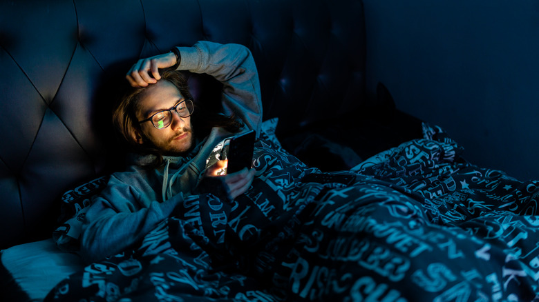 Man in bed using phone